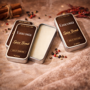 spice-bomb-solid-perfume-by-eaucosta-in-brown-metal-tin-with-open-balm-warm-spicy-woody-fragrance